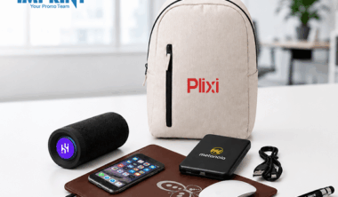 Promotional tech products including a branded backpack, speaker, power bank, mouse pad, and pen displayed as smart business swag.