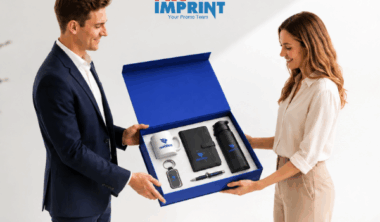 New hire receiving a branded welcome kit box with mug, notebook, keychain, and water bottle